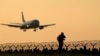 Czech Republic -- An airplane lands at the Vaclav Havel Airport as plane spotters wait for the departure of Antonov An-225 Mriya, a cargo plane which is the world's biggest aircraft, during sunrise in Prague, May 12, 2016.