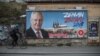 CZECH REPUBLIC -- A man rides his bicycle past a damaged election poster of Czech President Milos Zeman, who runs for re-election as Czech President in presidential elections, in Prague, January 11, 2018