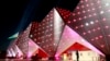 Azerbaijan - A woman stands in front of the illuminated building of Crystal Hall in Baku, Azerbaijan 25 June 2015. The Baku 2015 European Games will run until 28 June