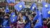 KOSOVO -- Kosovo children wave Kosovo flags on the main square in Pristina, February 13, 2018